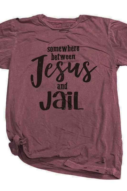 Somewhere Between Jesus and Jail Shown on the fabulous maroon destroyed tee, has all the rips and cuts in the right places, and so soft you could sleep in it. 100% ringspun and combed cotton soft tee. Unisex relaxed fit, slightly boxier than a regular tee.