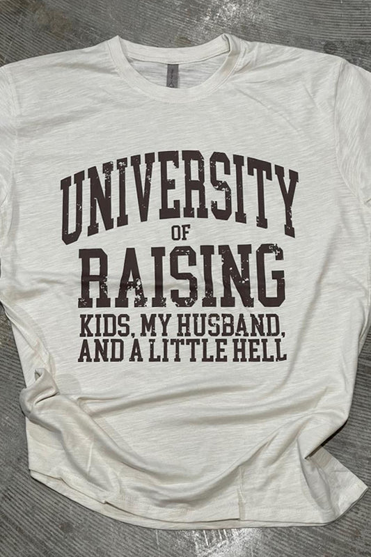 A white crew neck t-shirt with the text 'UNIVERSITY OF RAISING KIDS, MY HUSBAND, AND A LITTLE HELL' printed on the front.