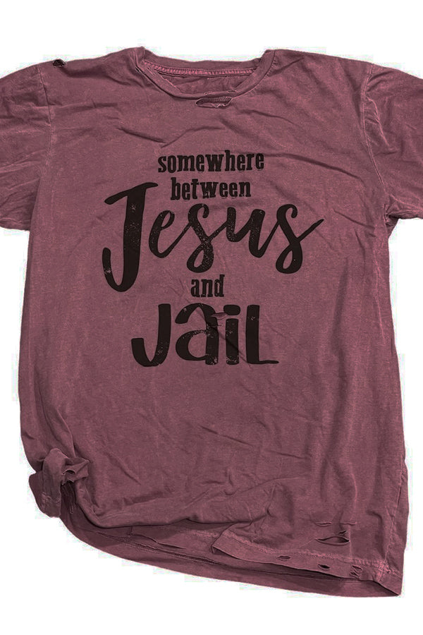 Somewhere Between Jesus and Jail Shown on the fabulous maroon destroyed tee, has all the rips and cuts in the right places, and so soft you could sleep in it. 100% ringspun and combed cotton soft tee. Unisex relaxed fit, slightly boxier than a regular tee.